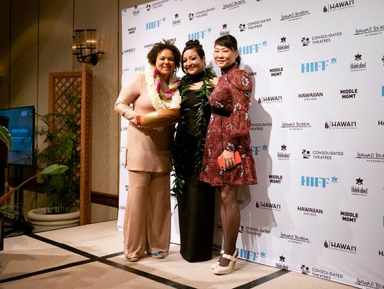 Producer Kerry Warkia of KĀINGA accepts the NETPAC Award from HIFF Executive Director Beckie Stocketti, with   Pacific Islander in Communication Executive Director Cheryl Hirasa